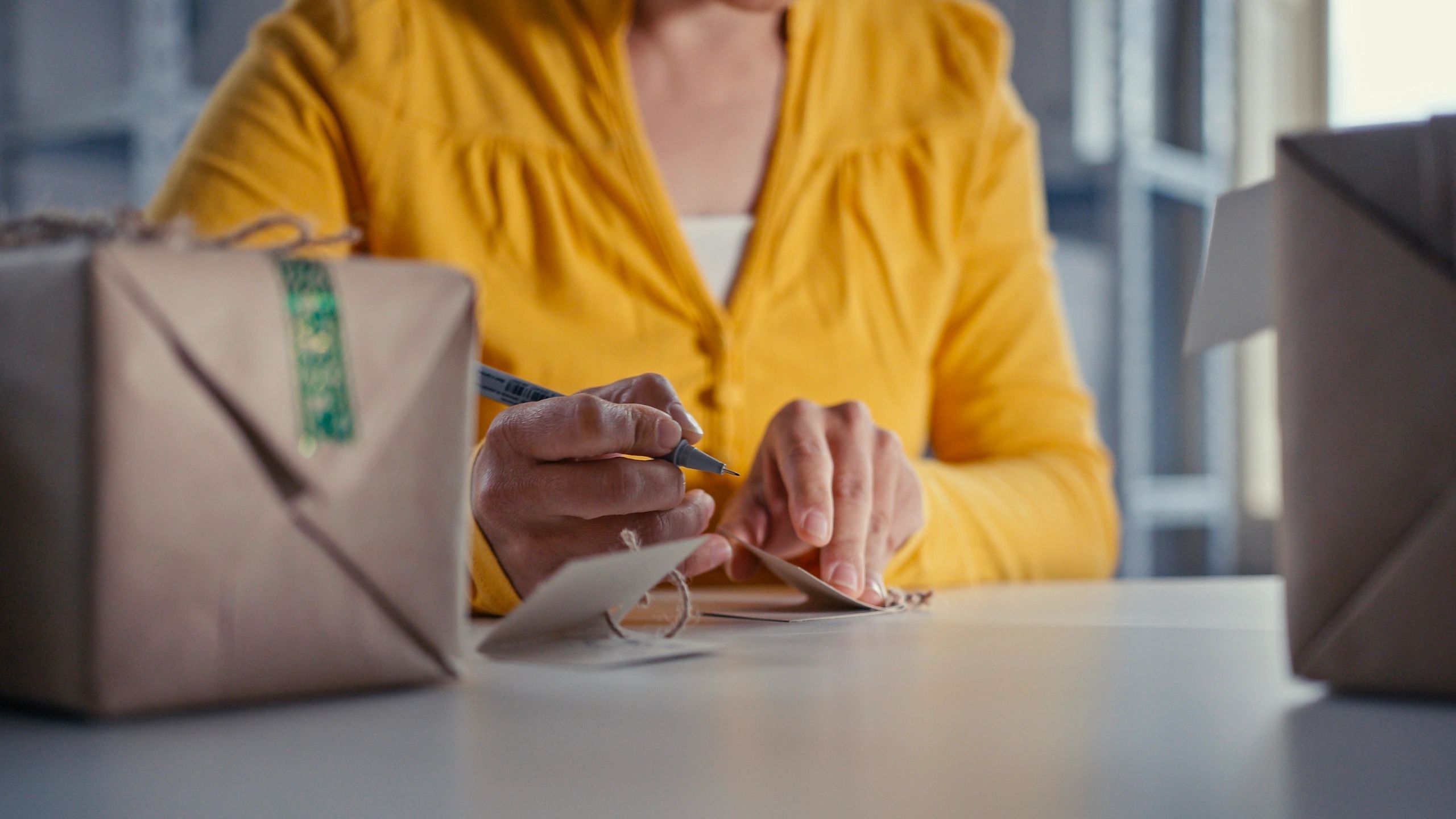 Hands wrapping a gift with ribbon