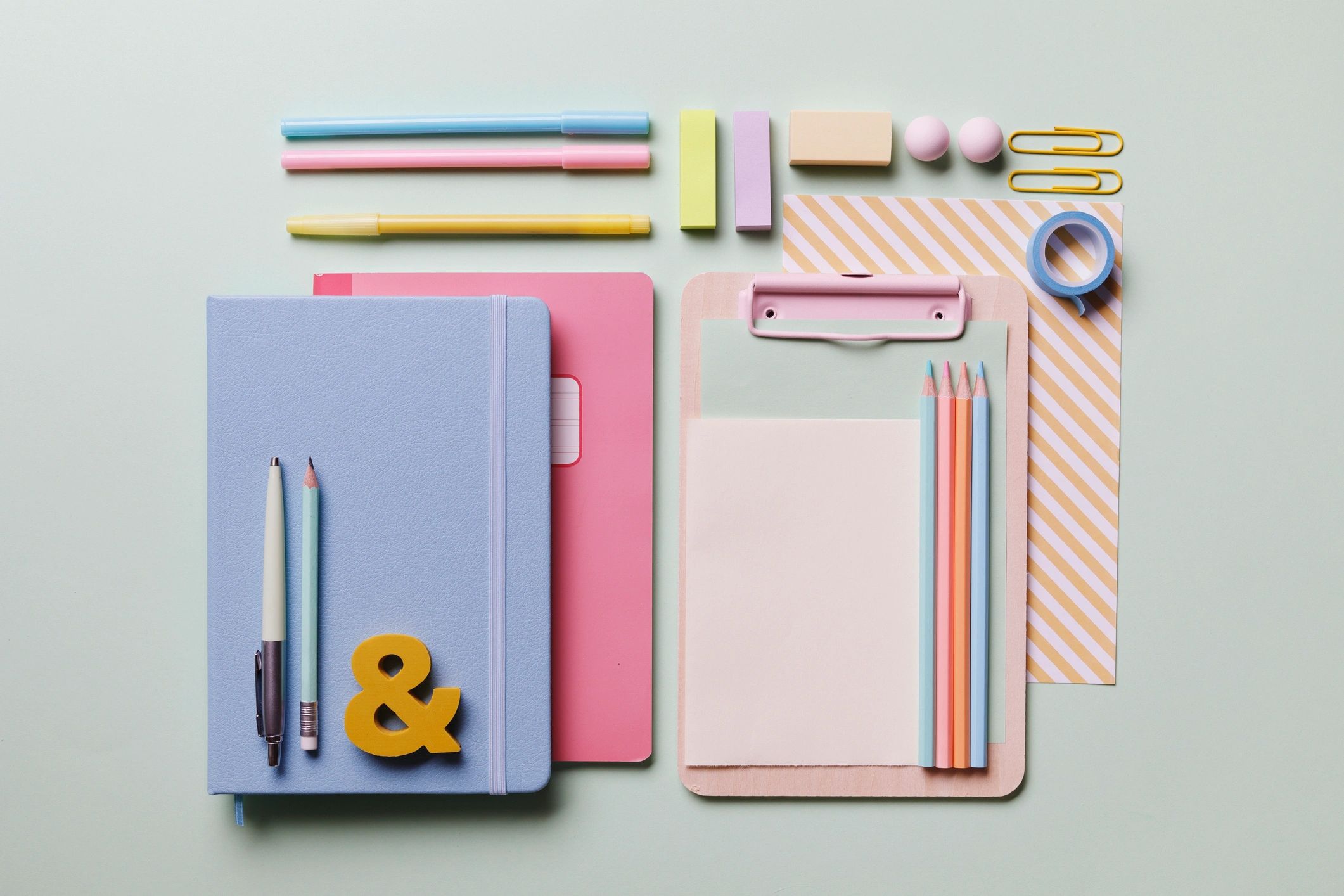 Pastel creative workspace with stationery and art supplies