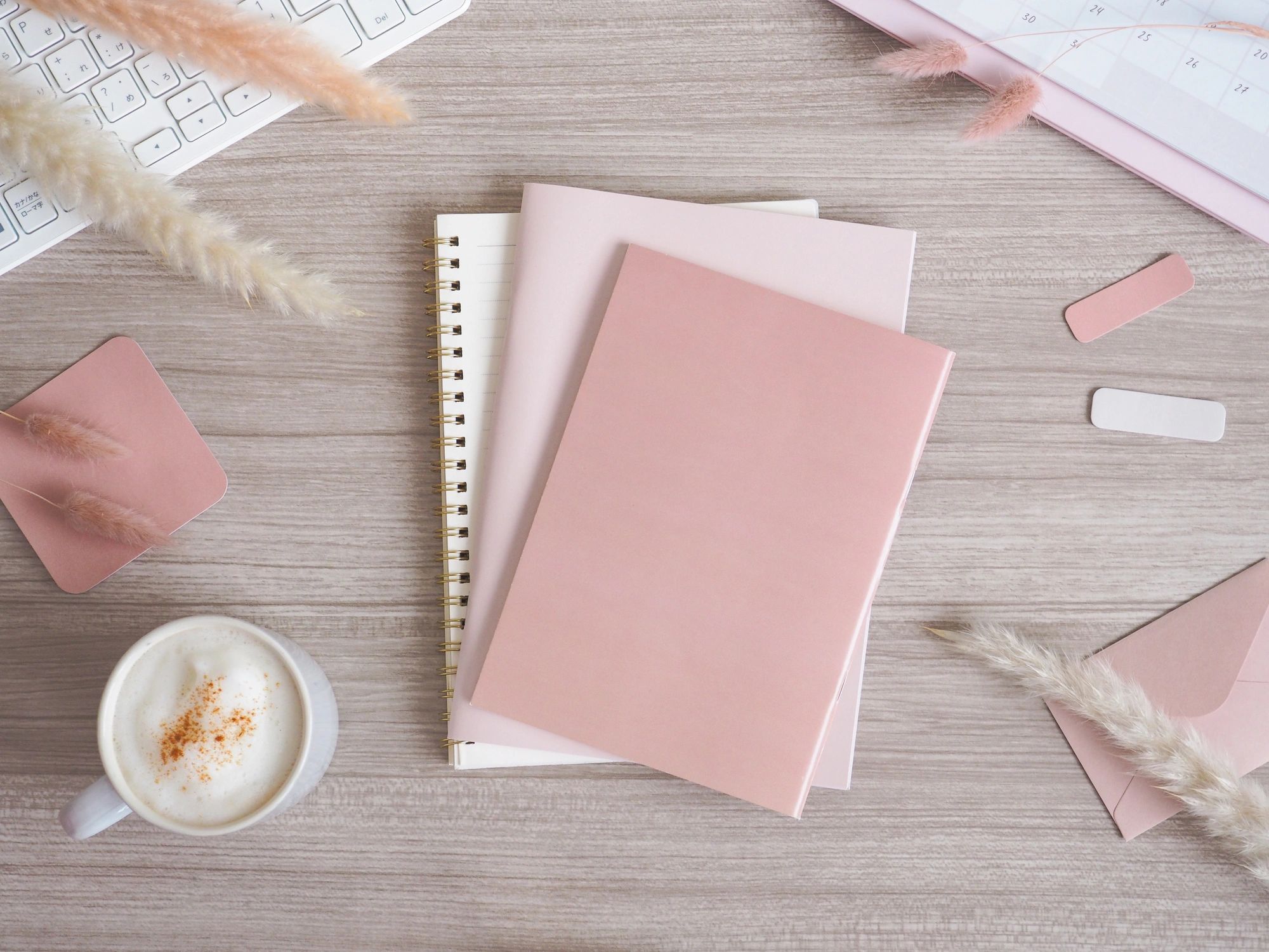 Pink and beige workspace flat lay with accessories