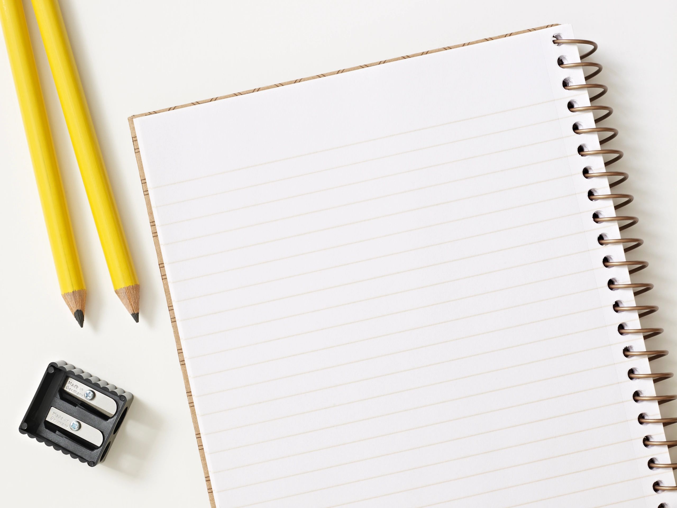 Pencils and notebook on a desk