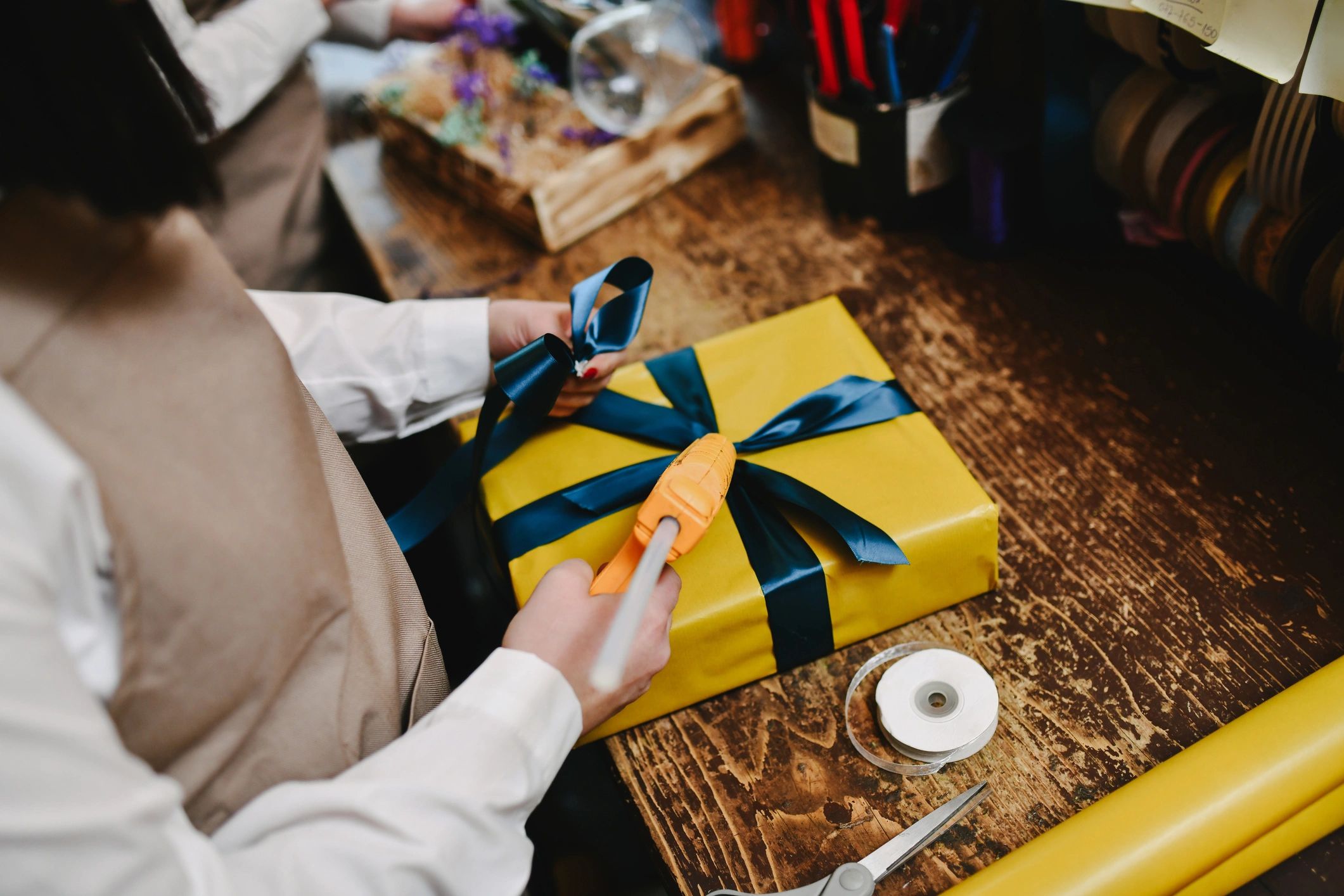 Wrapping a present with a blue bow