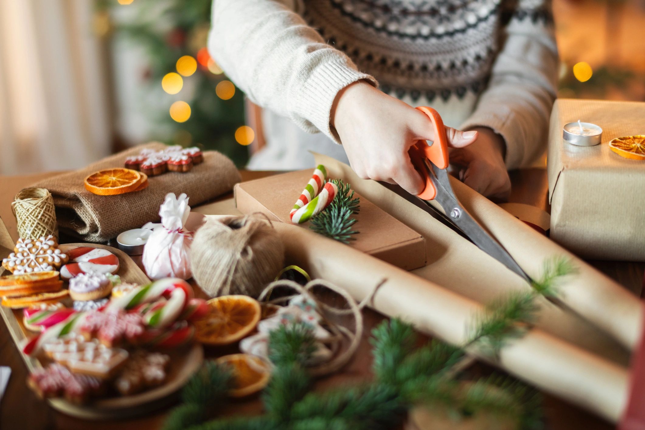 Person preparing wrapped gifts