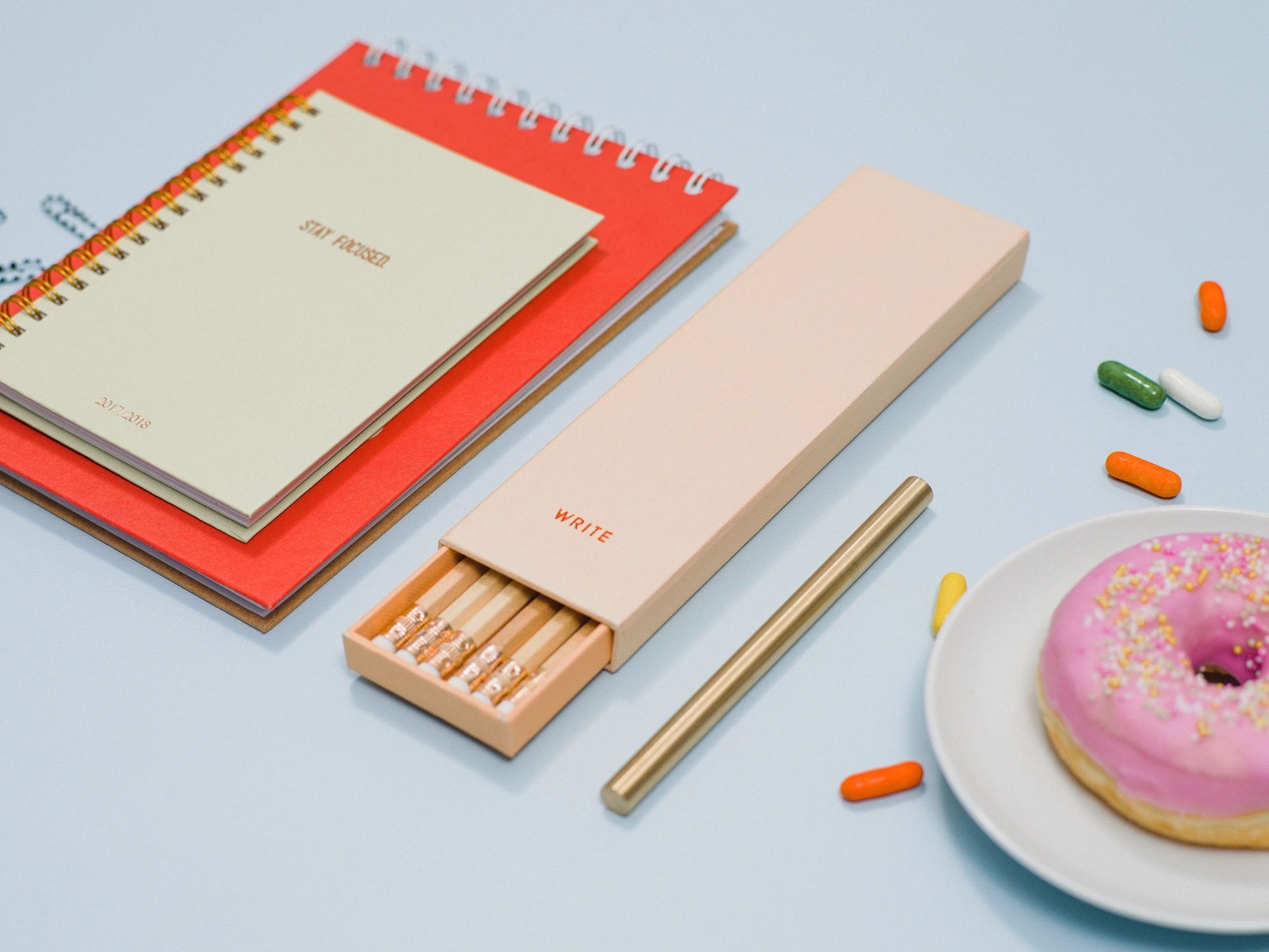 Stationery and notebook on a desk from above
