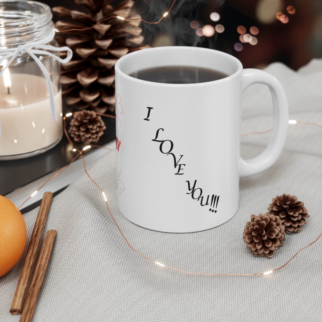 Steaming coffee mug with pinecones and candle